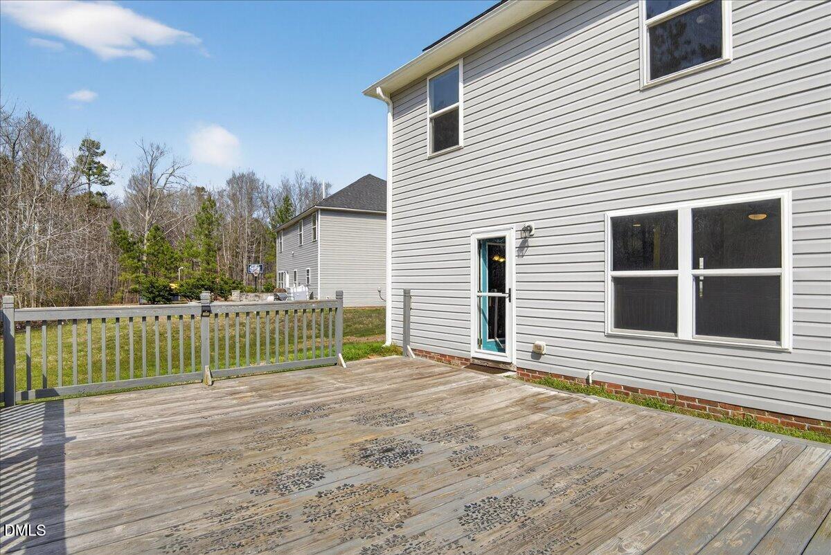 399 West Waycliff Road Henderson, NC 27537 - Photo 50 of 69 a view of a house with a small yard and wooden fence