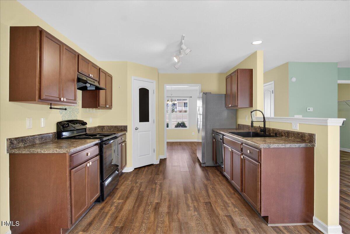 399 West Waycliff Road Henderson, NC 27537 - Photo 5 of 69 a large kitchen with stainless steel appliances granite countertop a stove and a sink