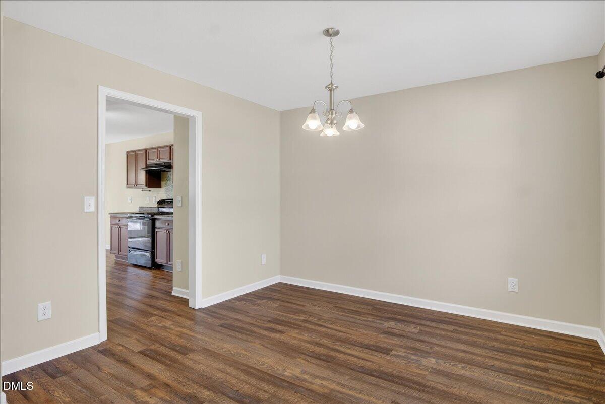 399 West Waycliff Road Henderson, NC 27537 - Photo 6 of 69 a view of a room with wooden floor and a ceiling fan