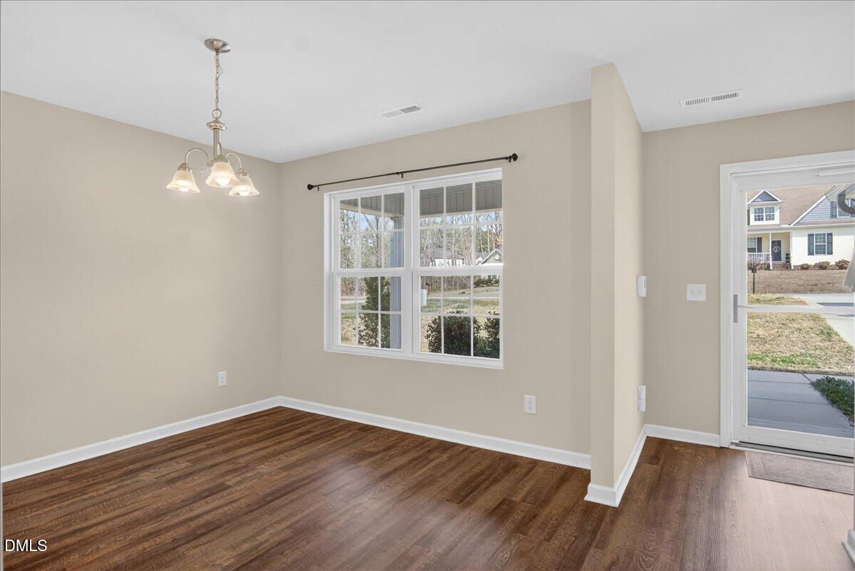 399 West Waycliff Road Henderson, NC 27537 - Photo 7 of 69 a view of a room with wooden floor and windows