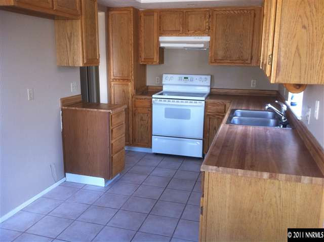 6199 Walnut Creek Road Reno, NV 89523 - Photo 4 of 6 a kitchen with a stove and a cabinets