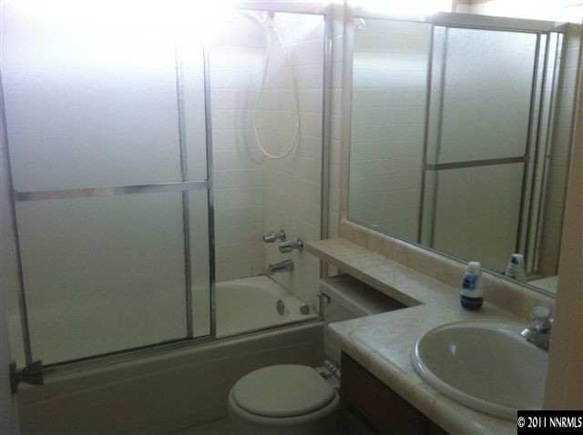 6199 Walnut Creek Road Reno, NV 89523 - Photo 6 of 6 a bathroom with a sink toilet and shower