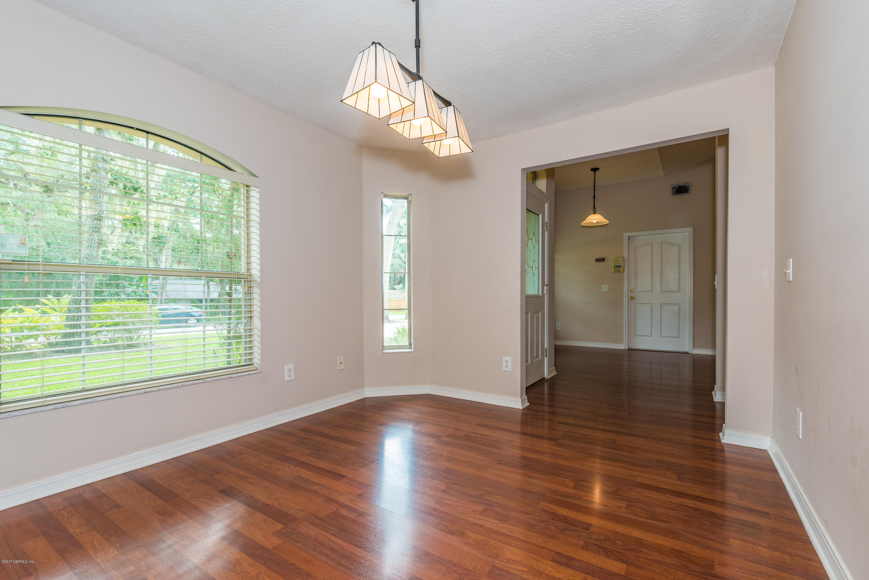 444 Orchis Road St. Augustine, FL 32086 - Photo 11 of 56 a view of an empty room with wooden floor and a window