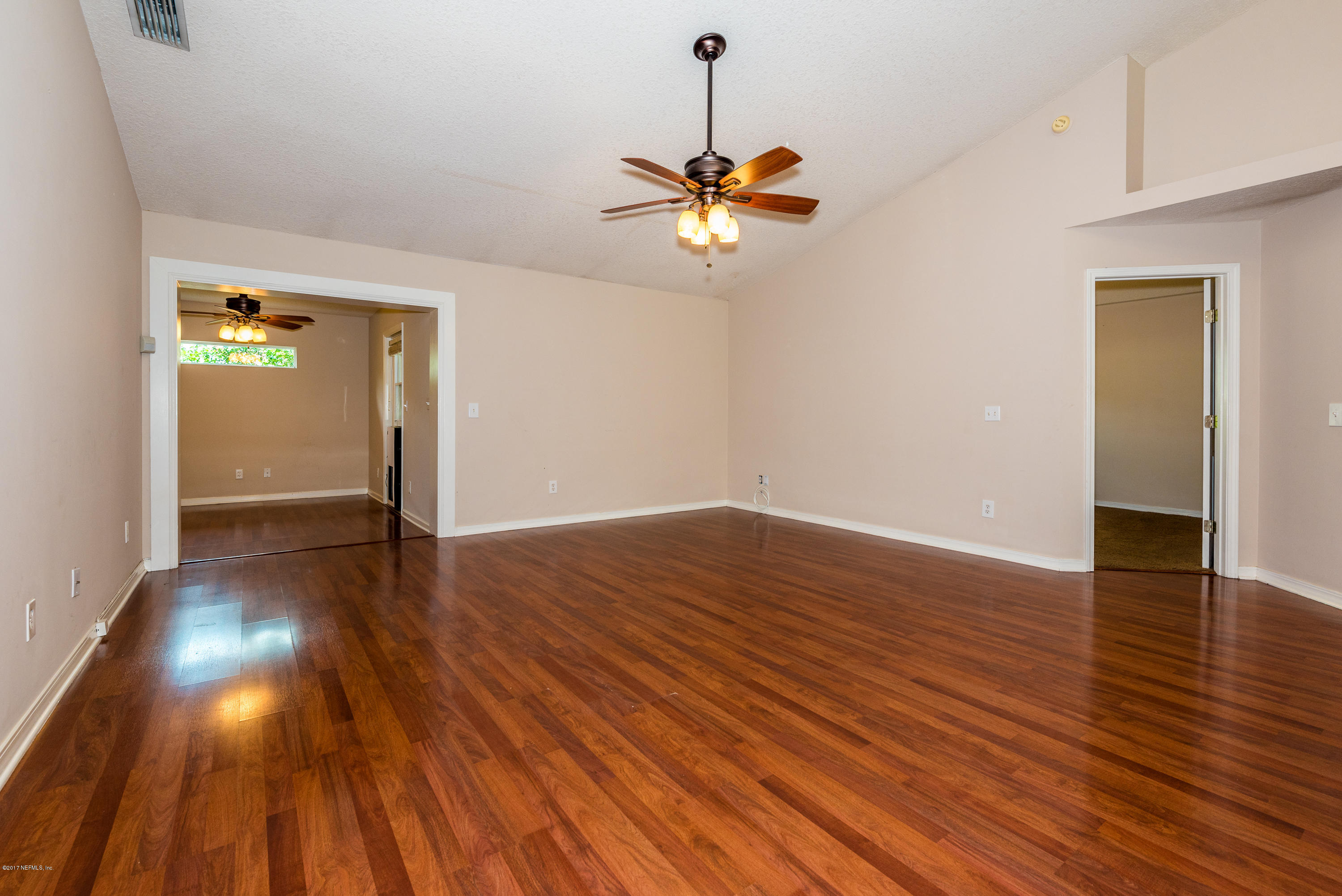 444 Orchis Road St. Augustine, FL 32086 - Photo 17 of 56 a view of a room with wooden floor and ceiling fan