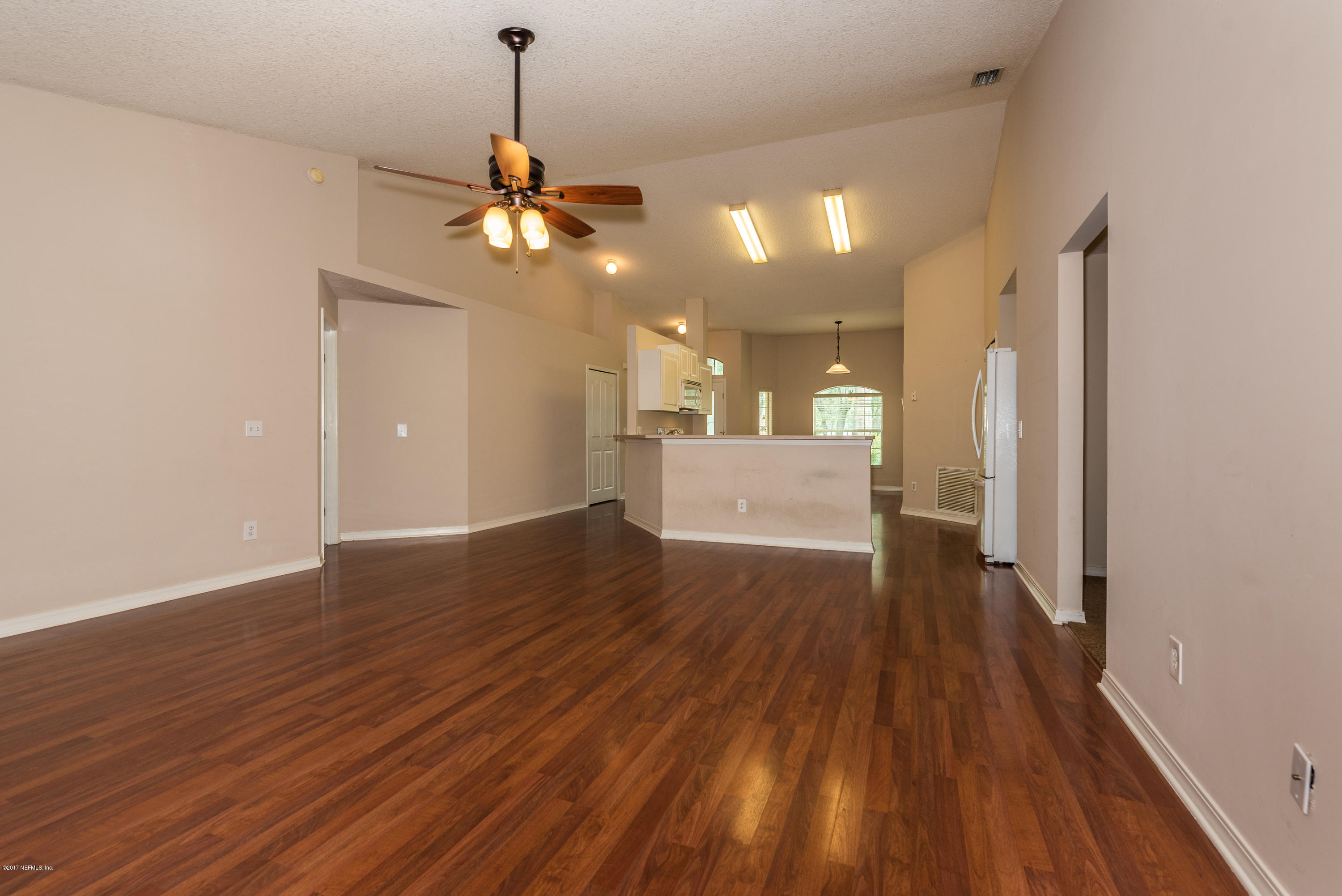 444 Orchis Road St. Augustine, FL 32086 - Photo 18 of 56 a view of a room with wooden floor and a ceiling fan