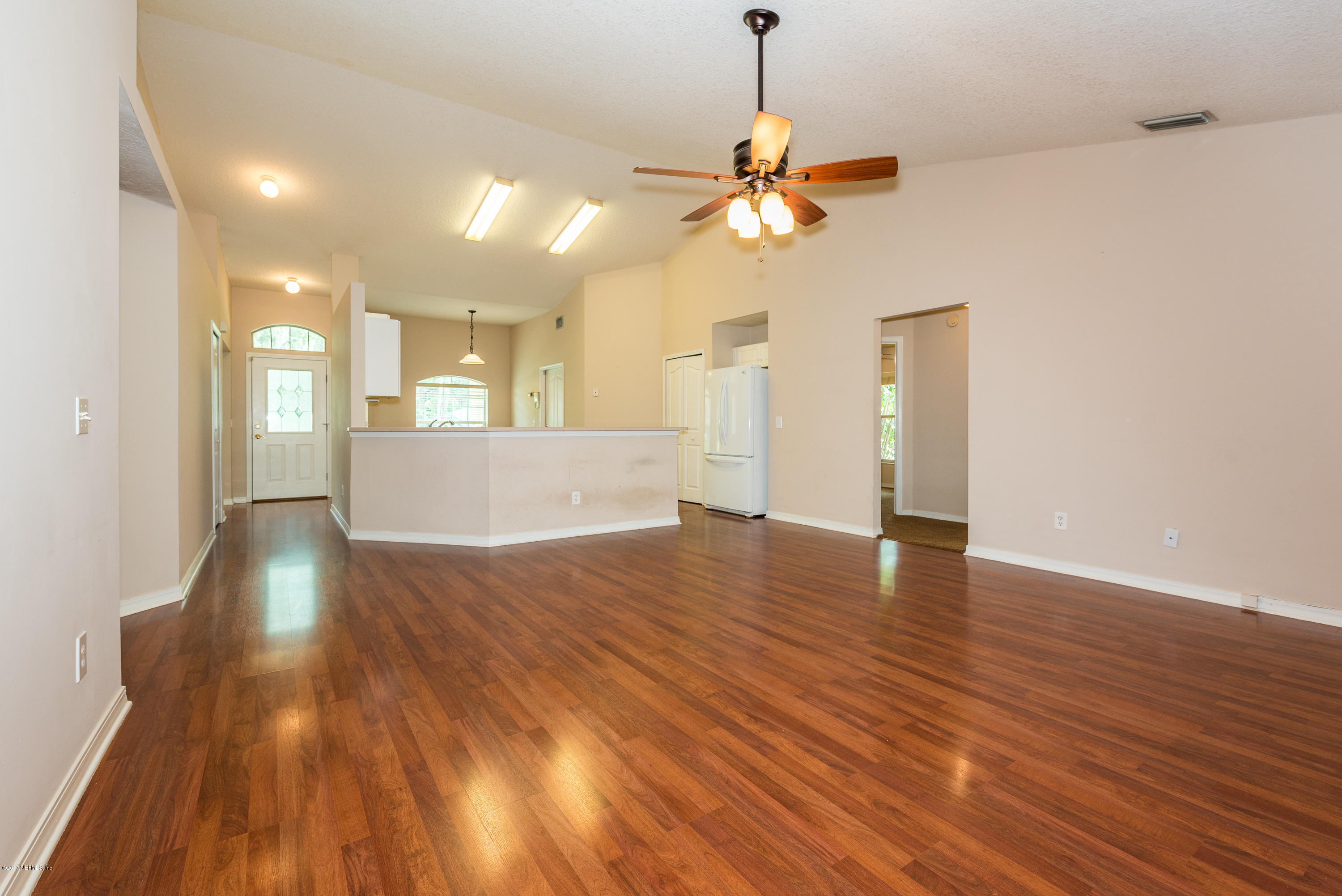 444 Orchis Road St. Augustine, FL 32086 - Photo 19 of 56 a view of an empty room with wooden floor and a ceiling fan