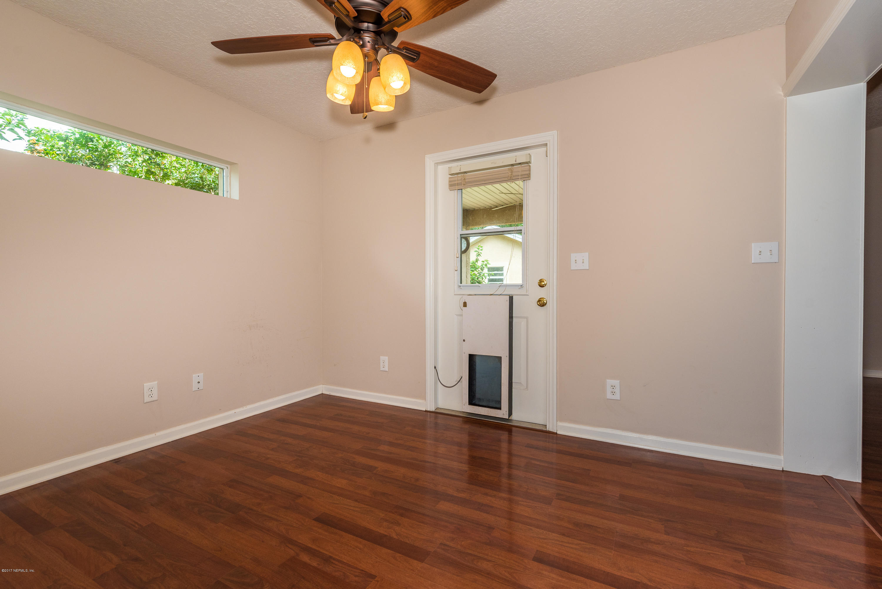 444 Orchis Road St. Augustine, FL 32086 - Photo 21 of 56 an empty room with wooden floor fan and windows