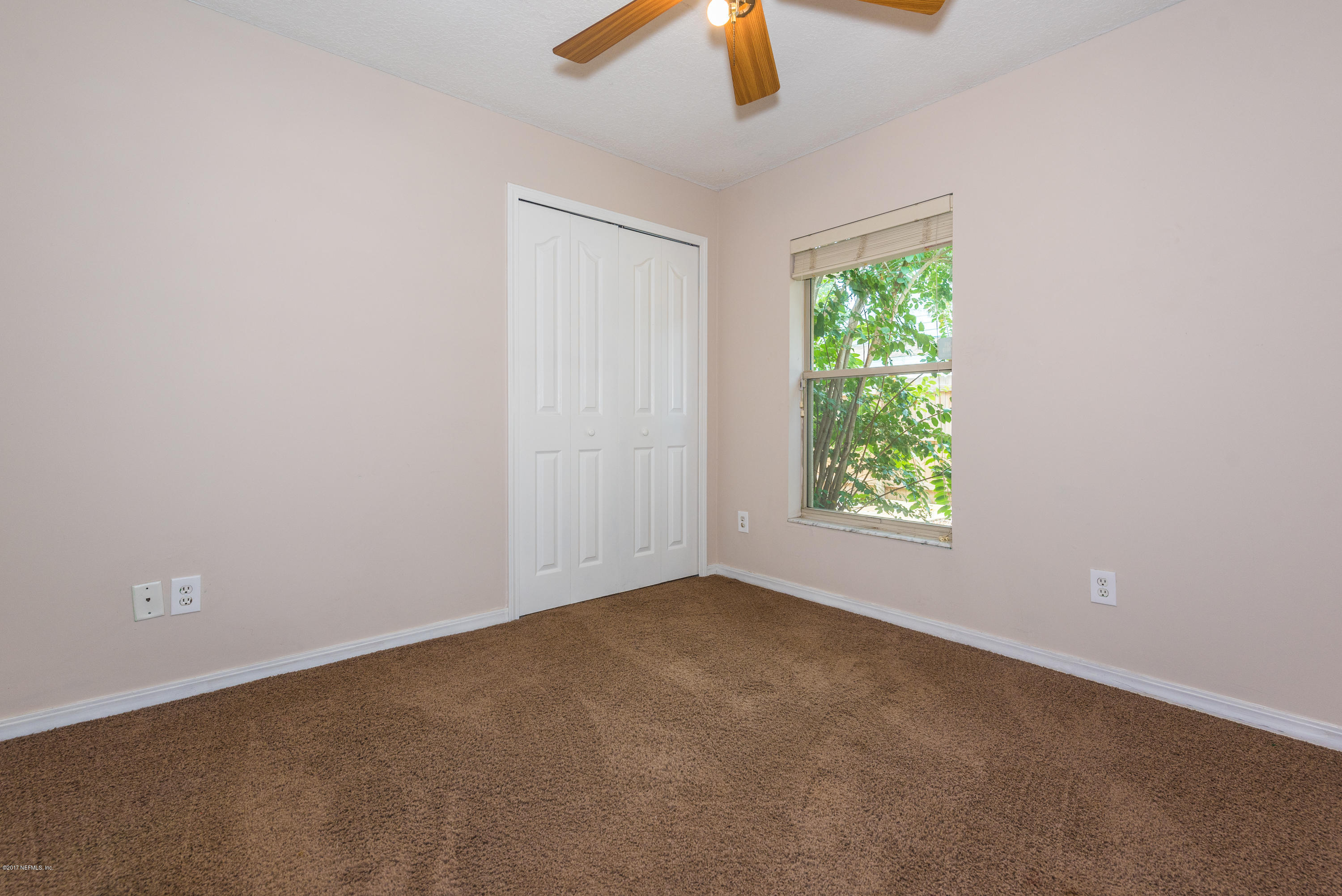 444 Orchis Road St. Augustine, FL 32086 - Photo 23 of 56 an empty room with windows and fan