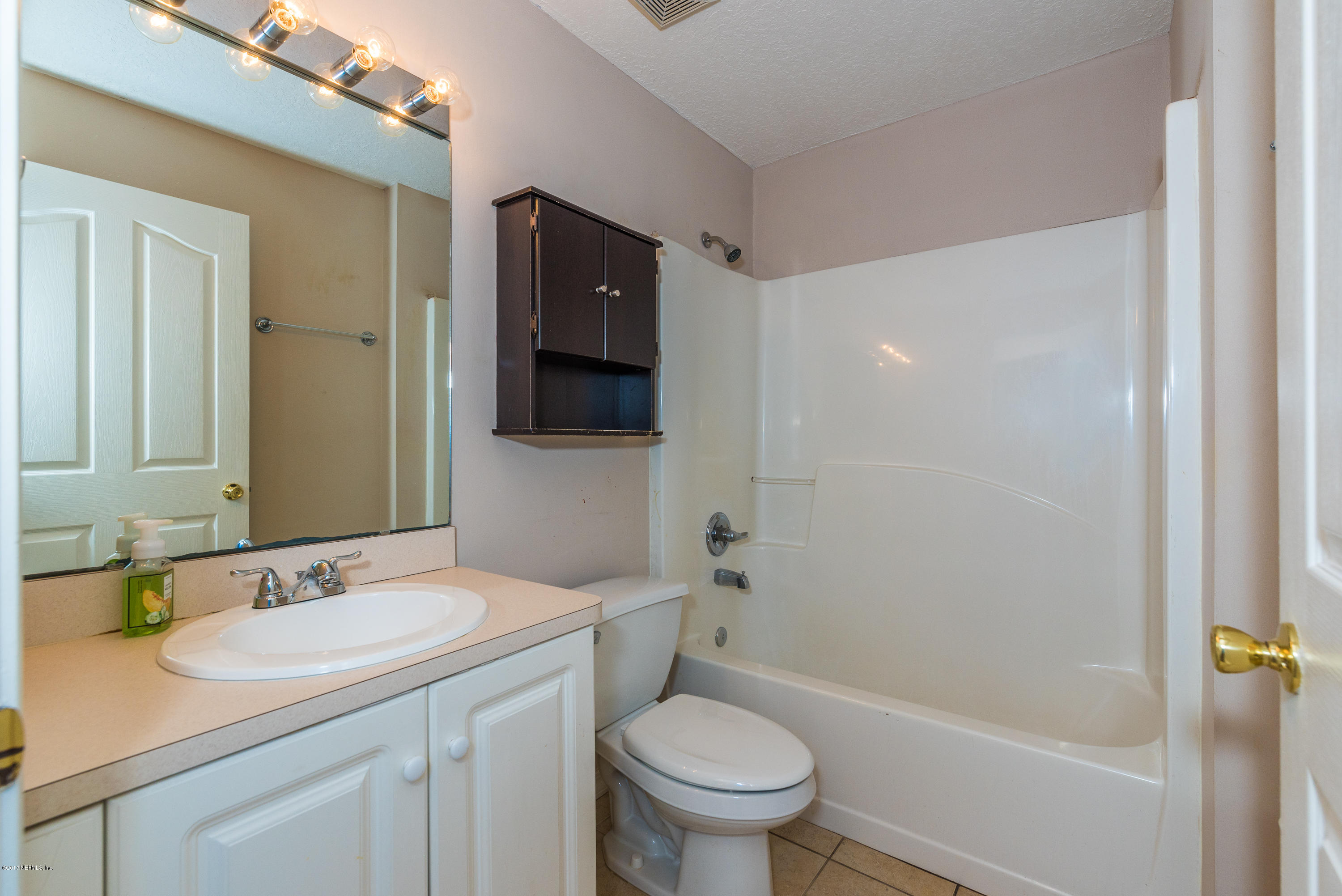 444 Orchis Road St. Augustine, FL 32086 - Photo 24 of 56 a bathroom with a granite countertop sink toilet and shower