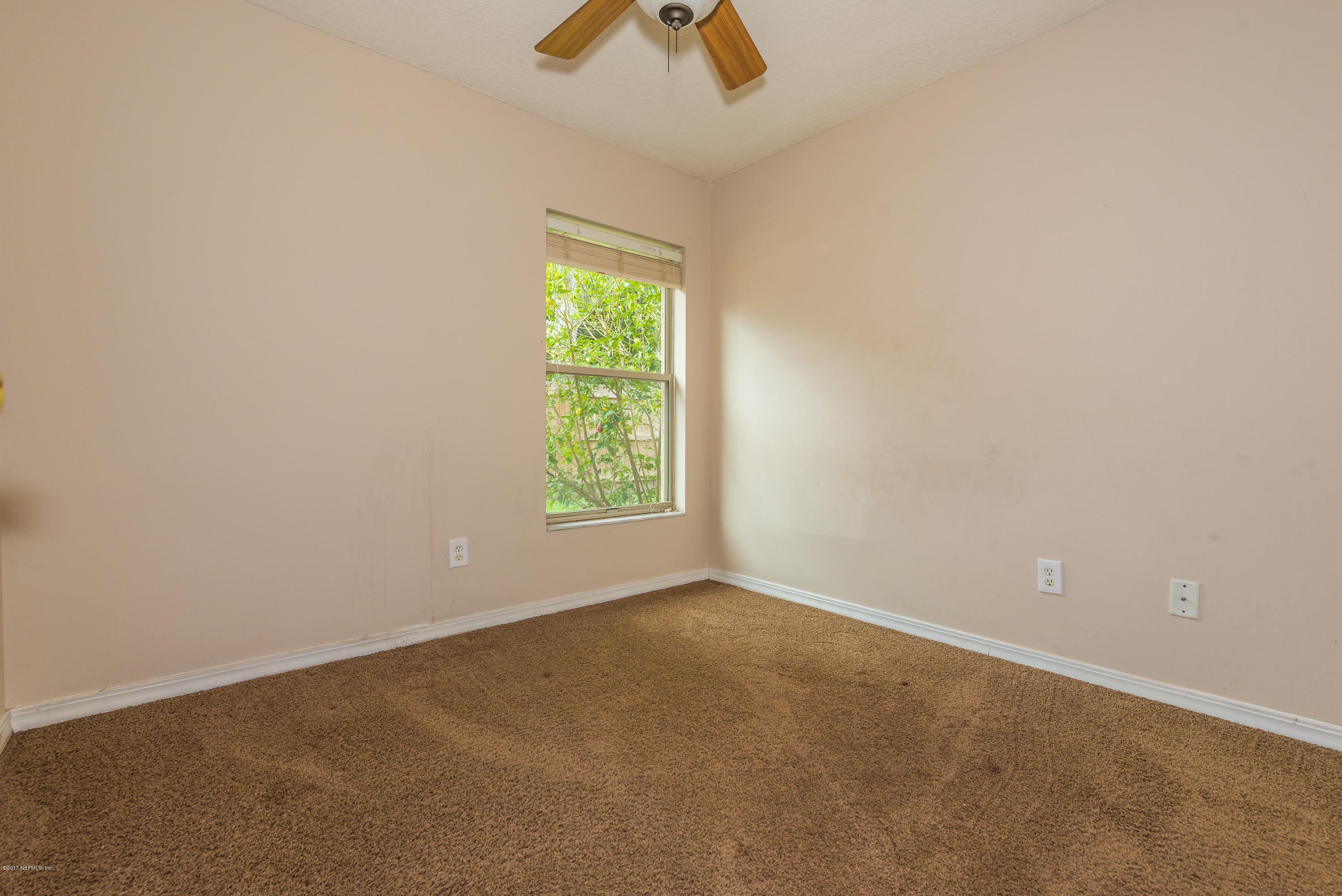 444 Orchis Road St. Augustine, FL 32086 - Photo 25 of 56 an empty room with a window and a fan