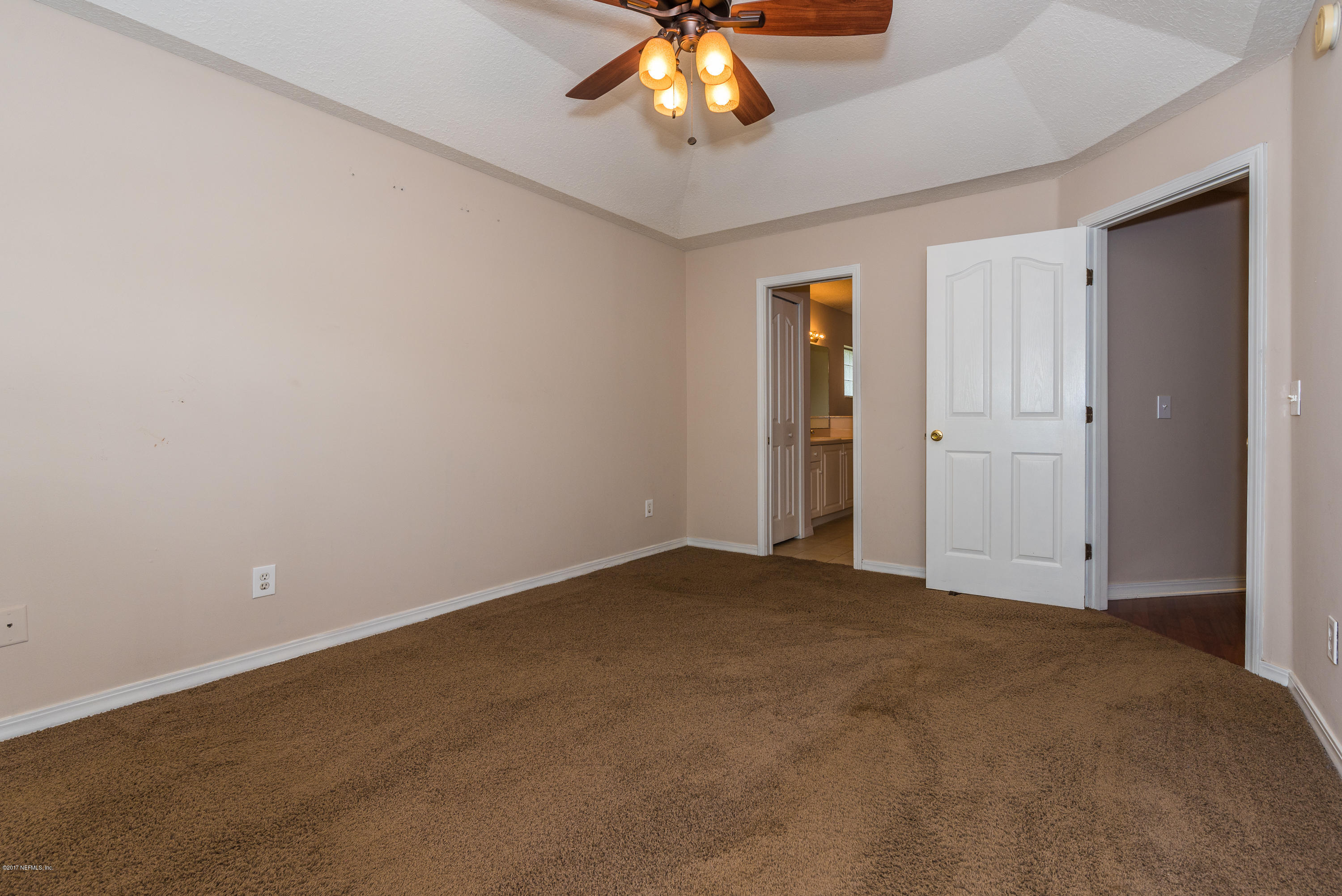 444 Orchis Road St. Augustine, FL 32086 - Photo 27 of 56 an empty room with a chandelier fan and closet