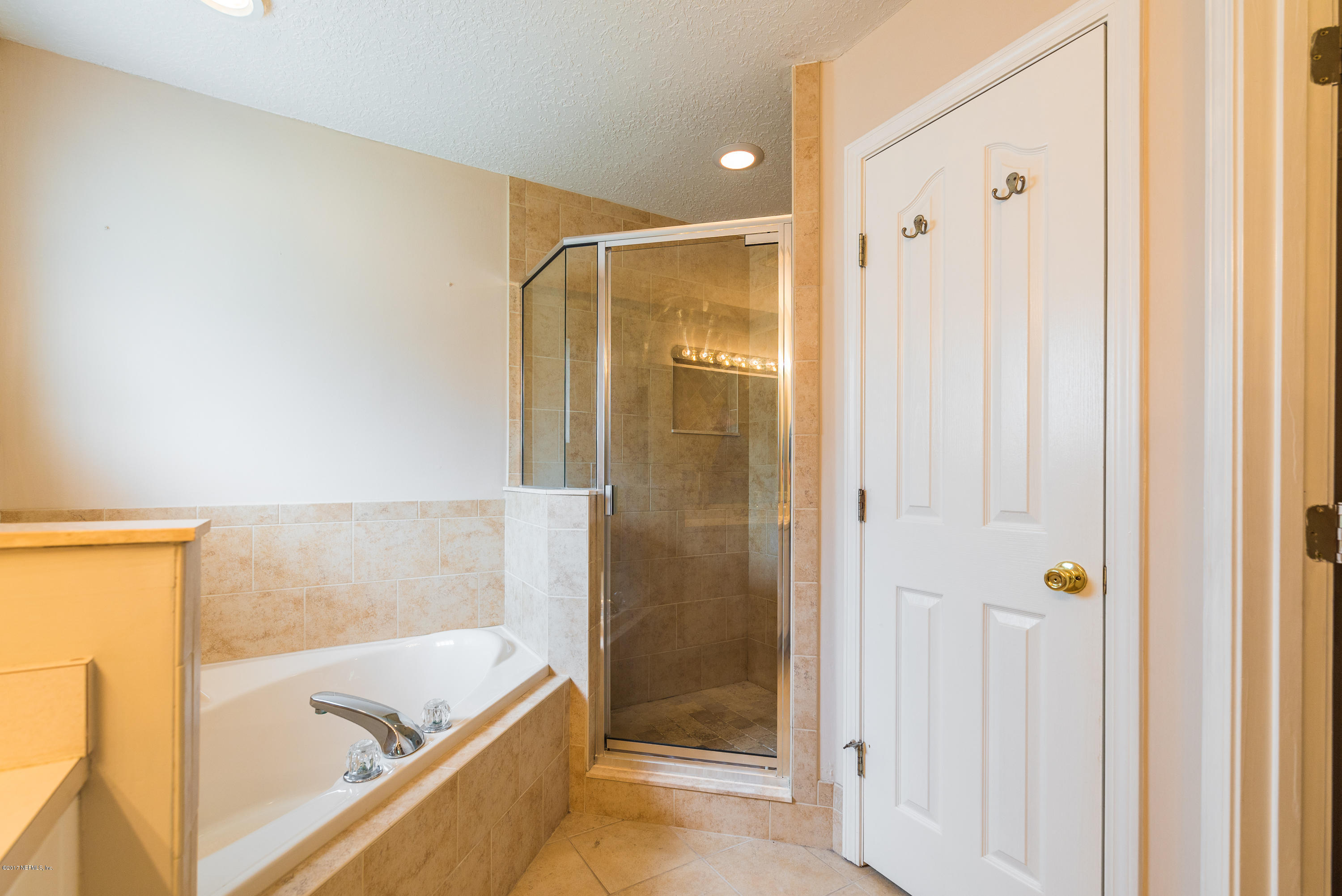 444 Orchis Road St. Augustine, FL 32086 - Photo 29 of 56 a bathroom with a bathtub and a shower
