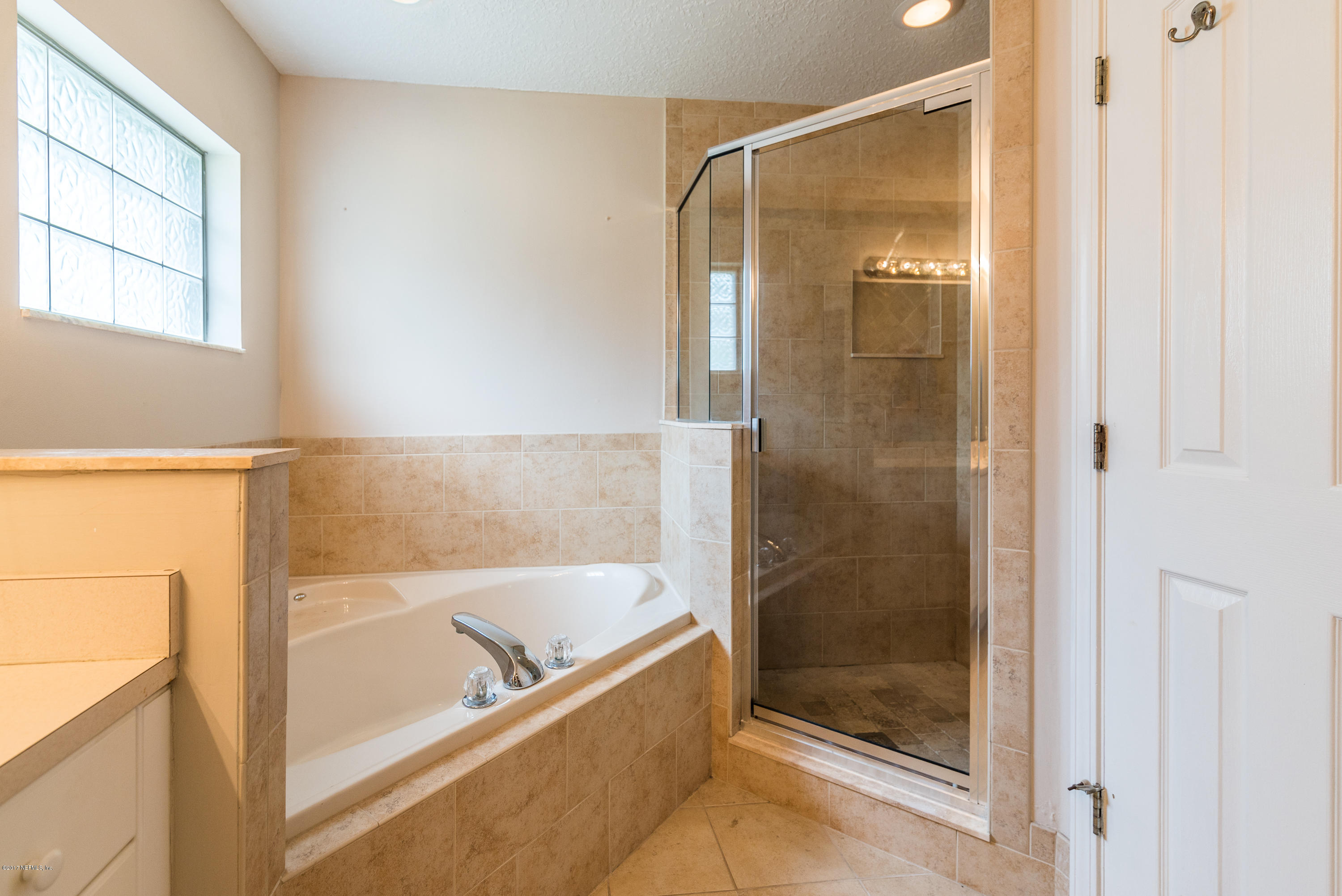 444 Orchis Road St. Augustine, FL 32086 - Photo 30 of 56 a bathroom with a tub and a shower