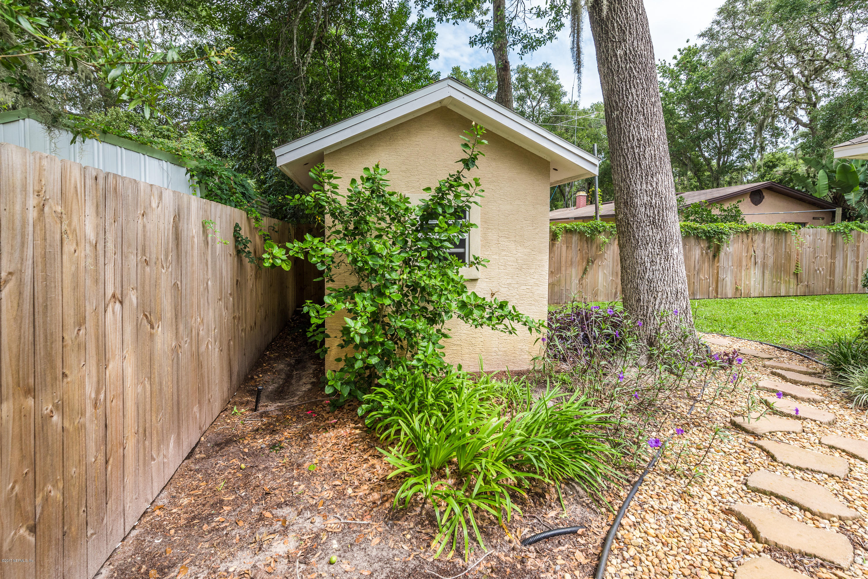 444 Orchis Road St. Augustine, FL 32086 - Photo 40 of 56 a view of a wooden house with a small yard and plants