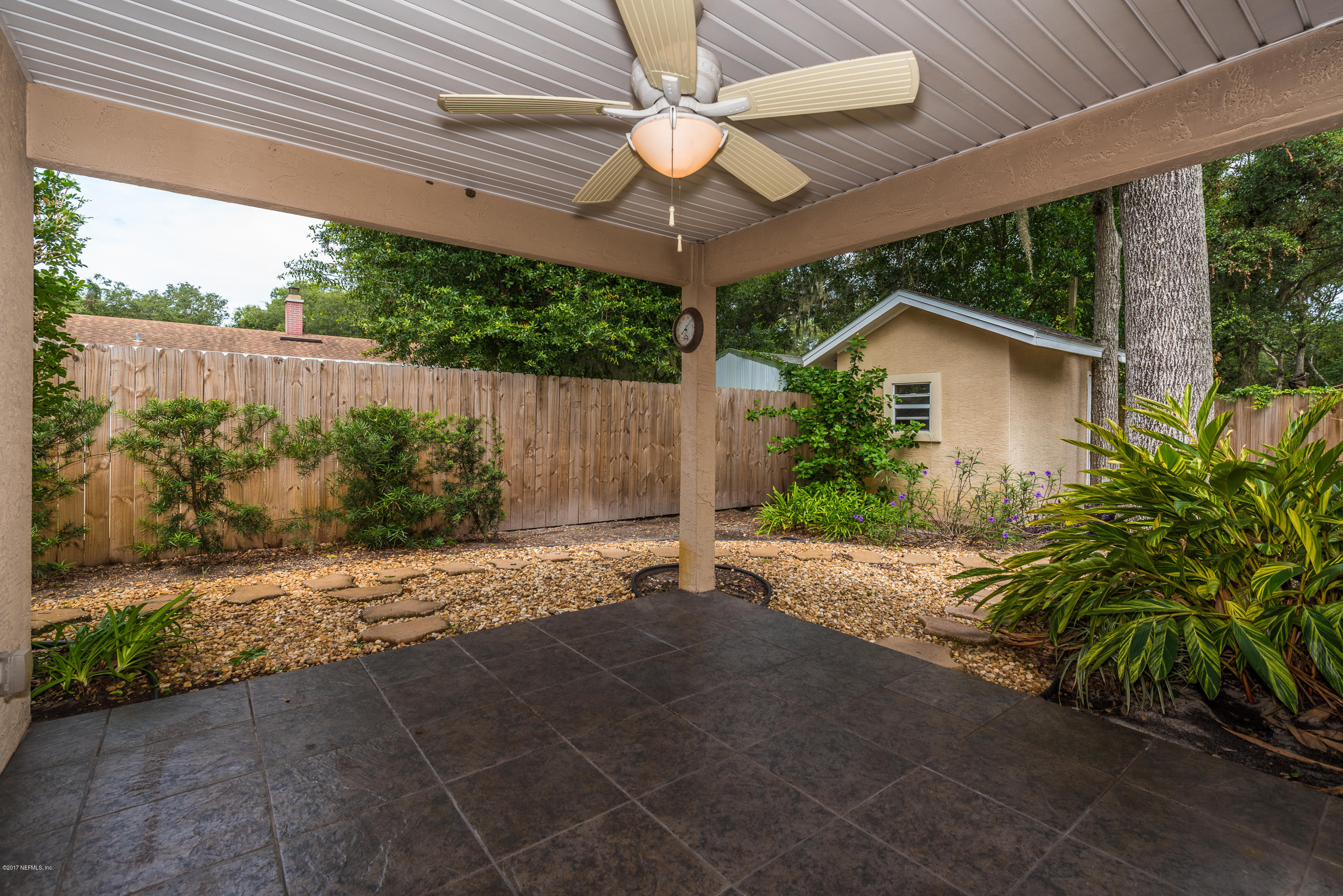 444 Orchis Road St. Augustine, FL 32086 - Photo 44 of 56 a view of a backyard with plants and a garden