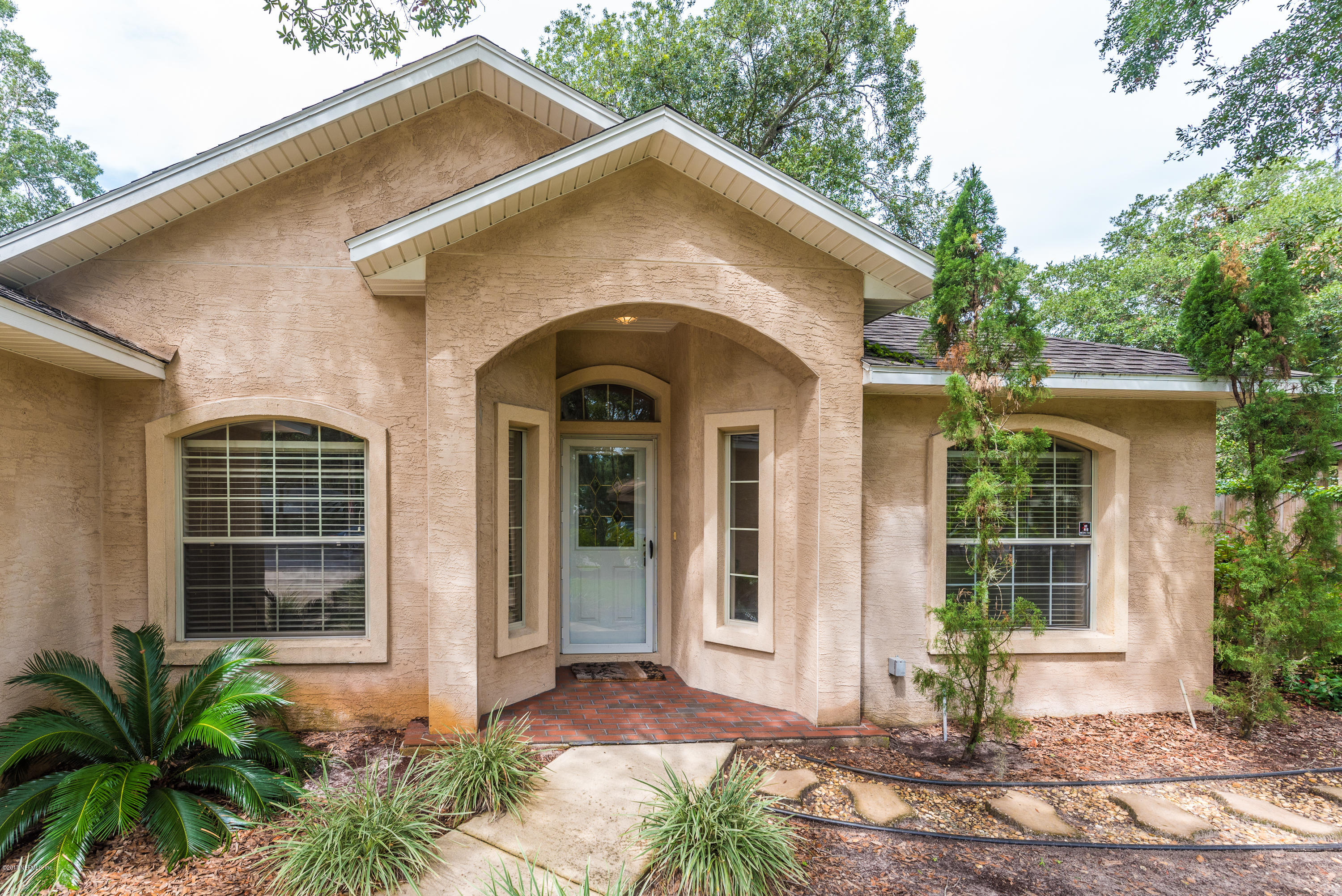 444 Orchis Road St. Augustine, FL 32086 - Photo 6 of 56 a front view of a house with a yard