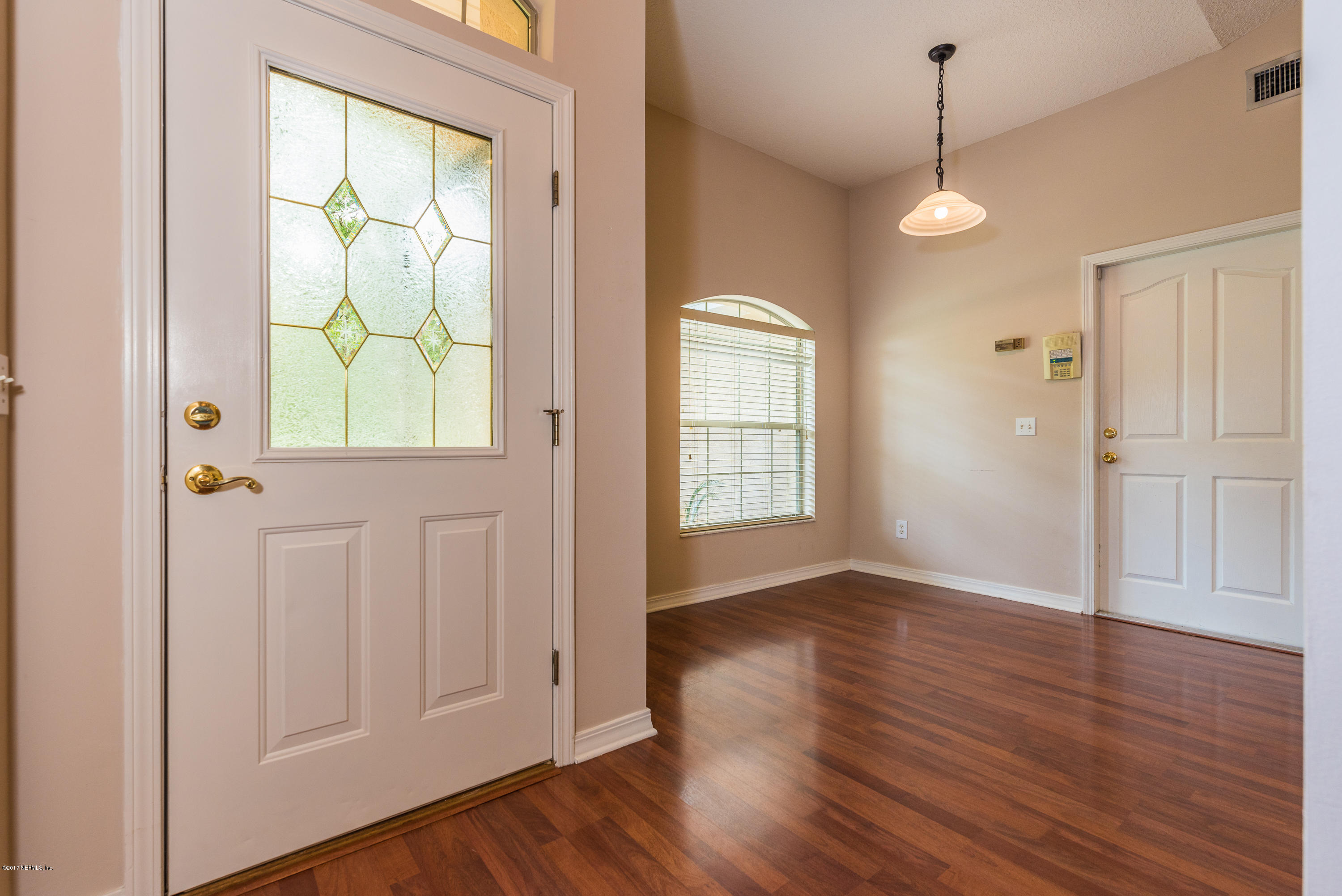 444 Orchis Road St. Augustine, FL 32086 - Photo 8 of 56 an empty room with wooden floor cabinet and windows