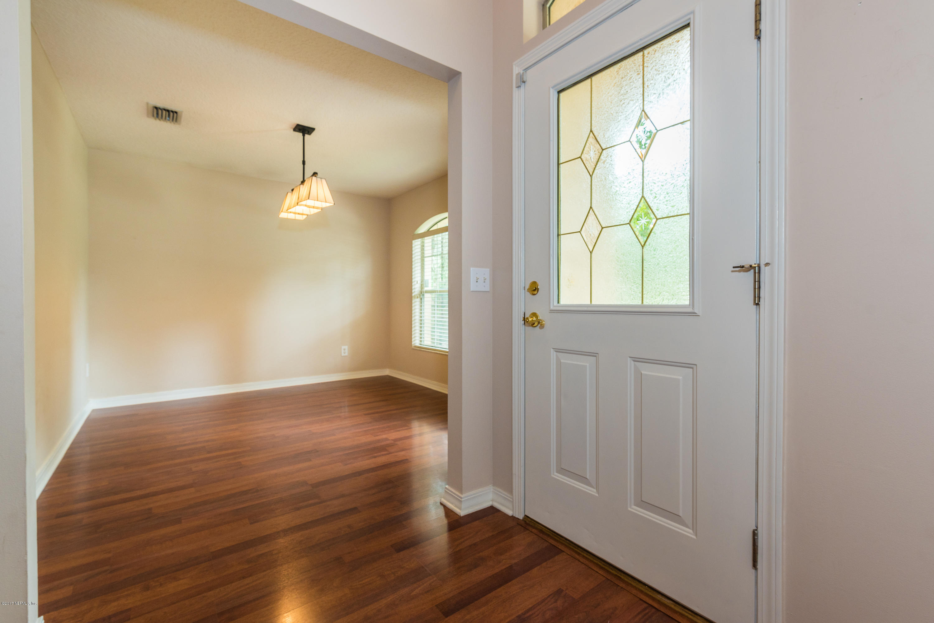444 Orchis Road St. Augustine, FL 32086 - Photo 9 of 56 an empty room with wooden floor and windows