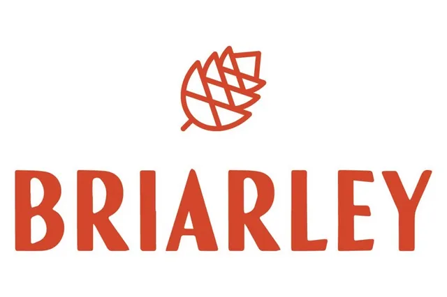 a view of large house with a large tree and plants