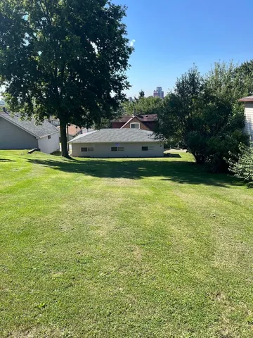 a view of yard with swimming pool and green space