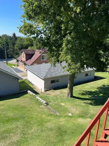 a view of a backyard with seating area
