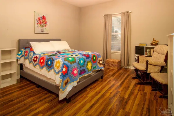 a bed sitting in a bedroom next to a window