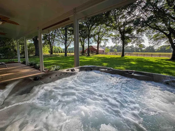 a view of a house with swimming pool and a yard
