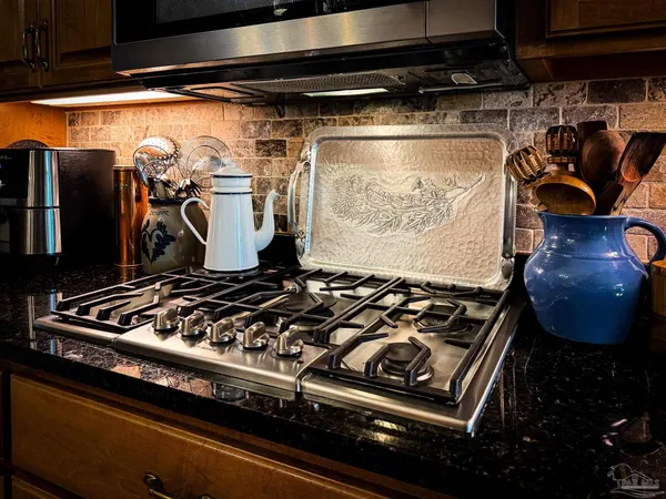 a kitchen with stainless steel appliances granite countertop a sink and cabinets