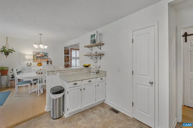a spacious bathroom with a granite countertop sink a mirror and shower