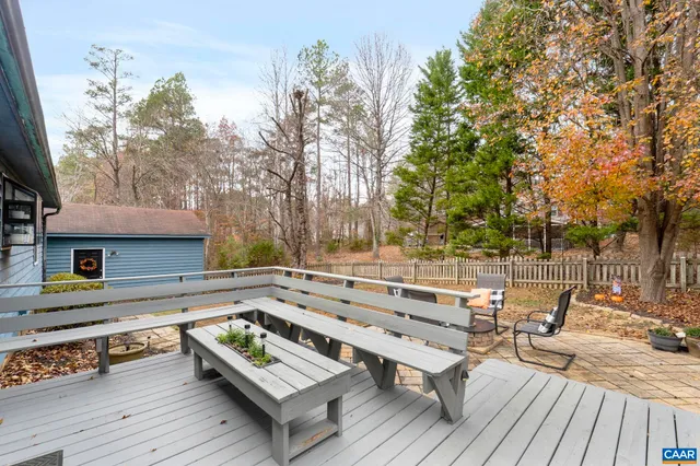 a view of a wooden deck with furniture
