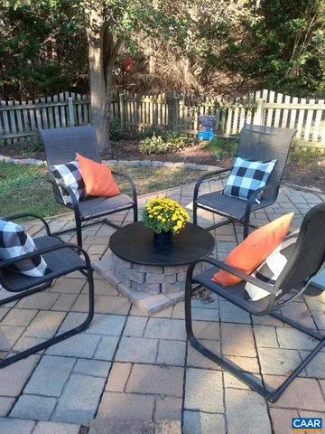 a view of a patio with a dining table and chairs