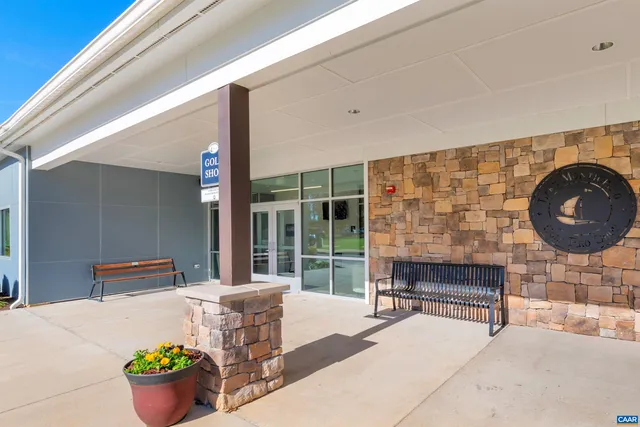 a building outdoor space with patio furniture and potted plants