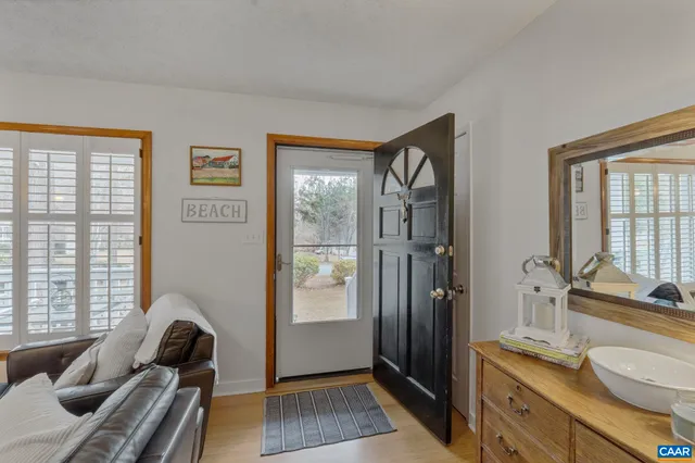 a bathroom with a granite countertop tub a double vanity sink a mirror and a window