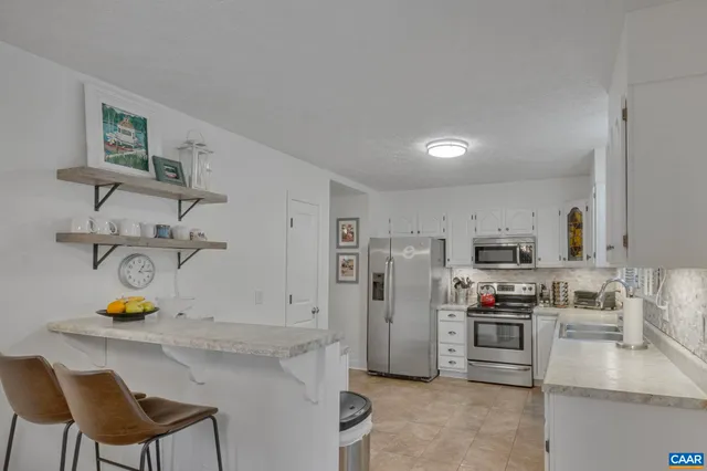 a kitchen with stainless steel appliances and a refrigerator