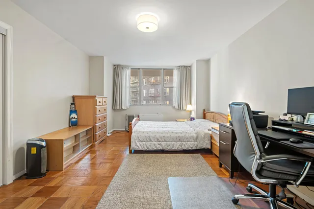 a bed room with a bed and a chair