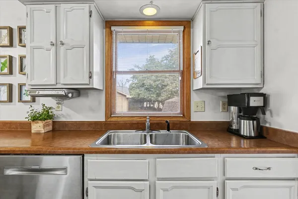 a kitchen with granite countertop a sink and a window
