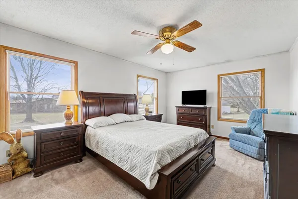 a bedroom with a large bed and a flat screen tv