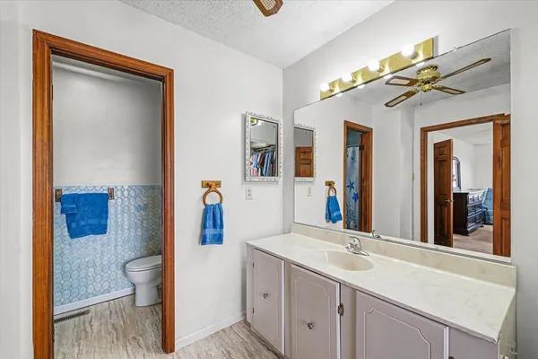 a bathroom with a sink a toilet and a mirror