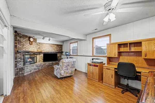 a living room with furniture a fireplace and a flat screen tv