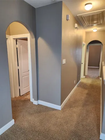 a view of a hallway with front door