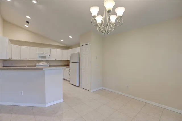 a view of a kitchen with a sink and dishwasher a stove top oven with wooden floor