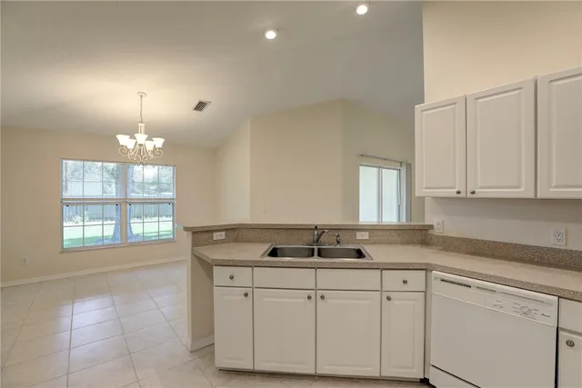 a kitchen with a sink and refrigerator