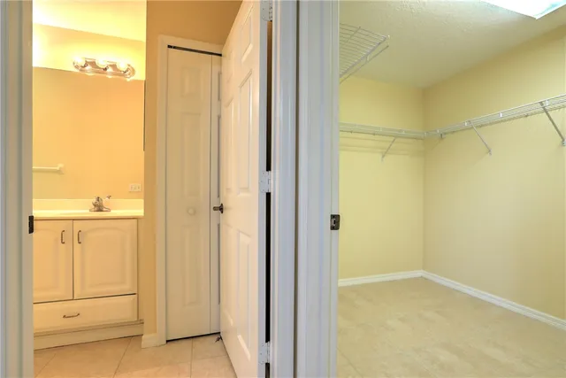 a bathroom with a double vanity sink toilet mirror and bathtub
