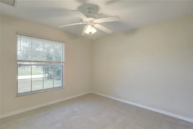 an empty room with fan and a ceiling fan