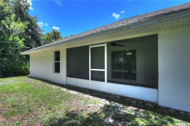 a view of house with backyard