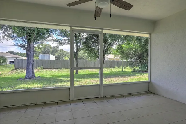 a view of a hallway with a ceiling fan