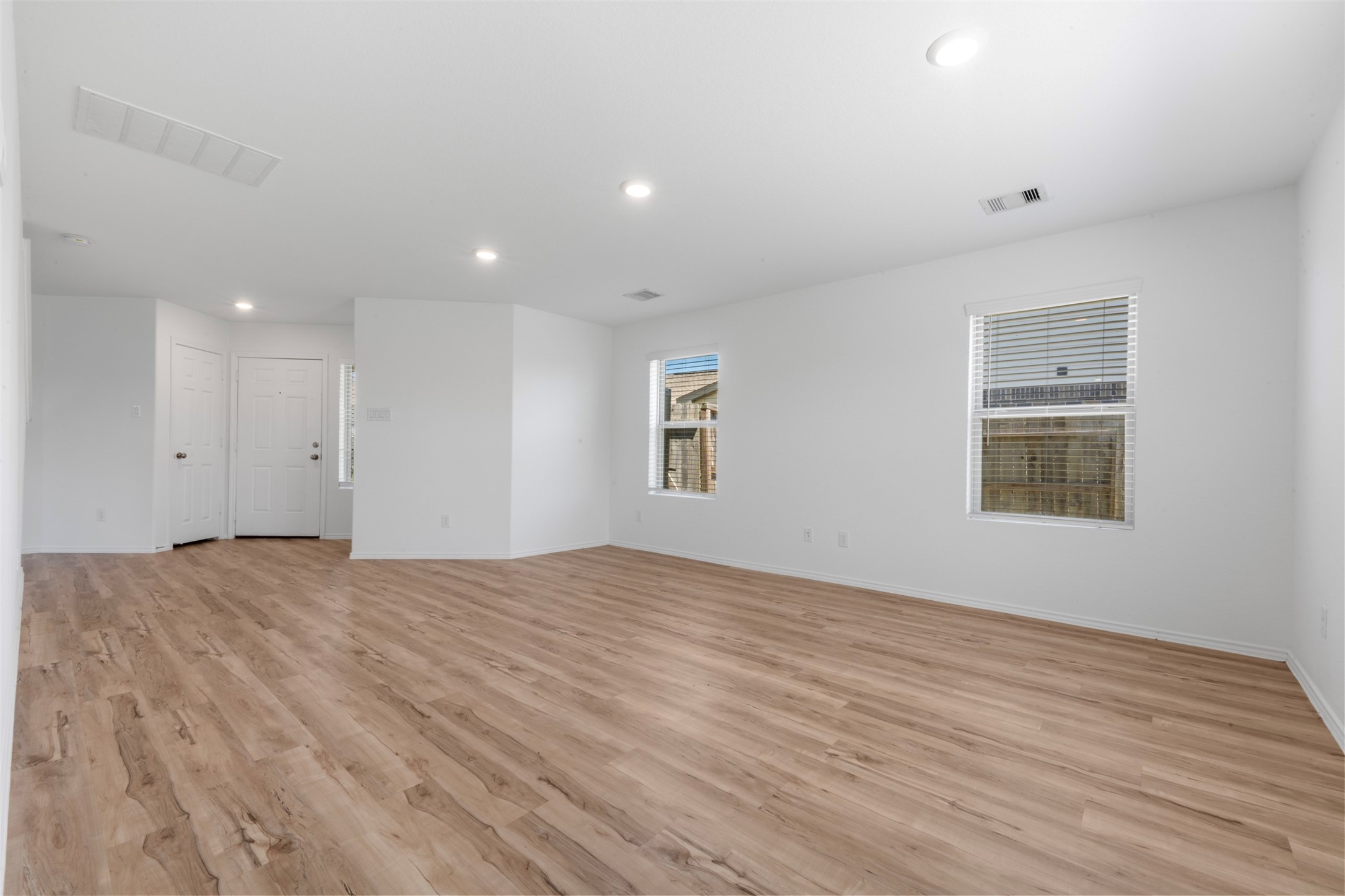 14602 Broadbury Pond Road Rosharon, TX 77583 - Photo 7 of 22 a view of an empty room with wooden floor and a window