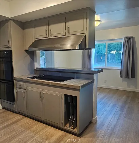 a kitchen with granite countertop a refrigerator and a sink