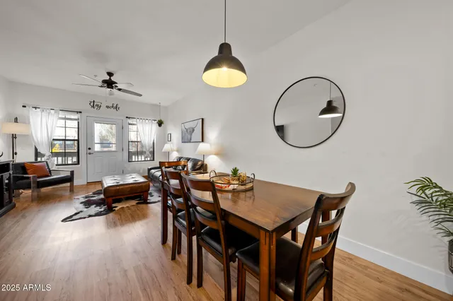 a view of a dining room with furniture and wooden floor