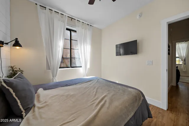 a bedroom with a bed and a flat screen tv